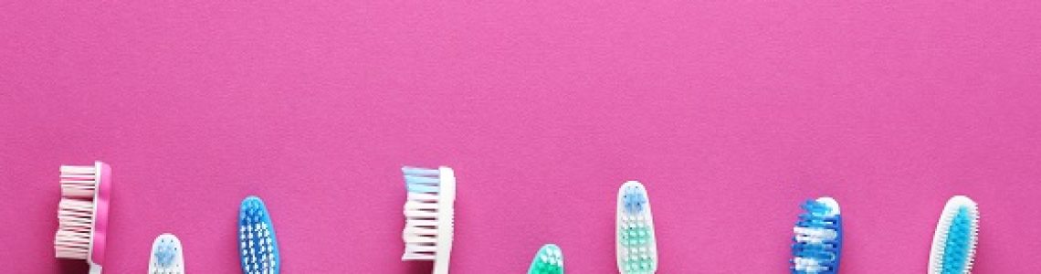 Toothbrushes,On,Pink,Background
