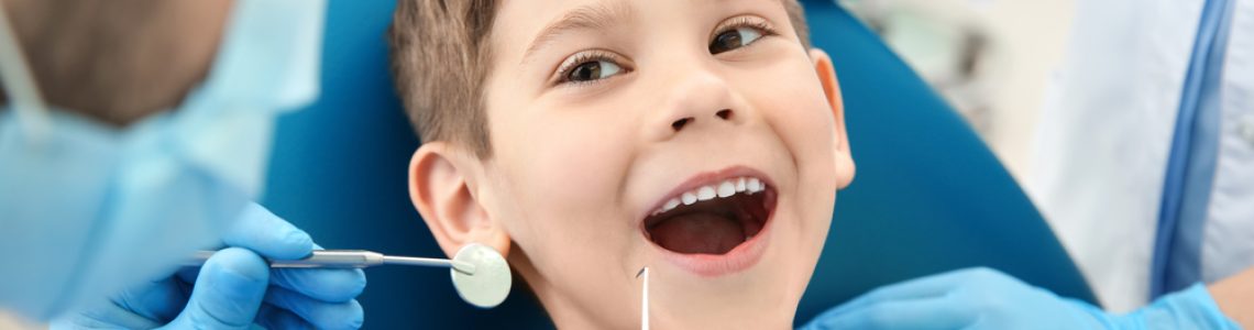 Dentist,Examining,Little,Boy's,Teeth,In,Clinic